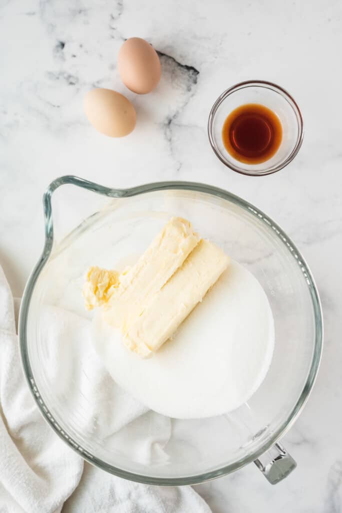 Butter and sugar in glass mixing bowl