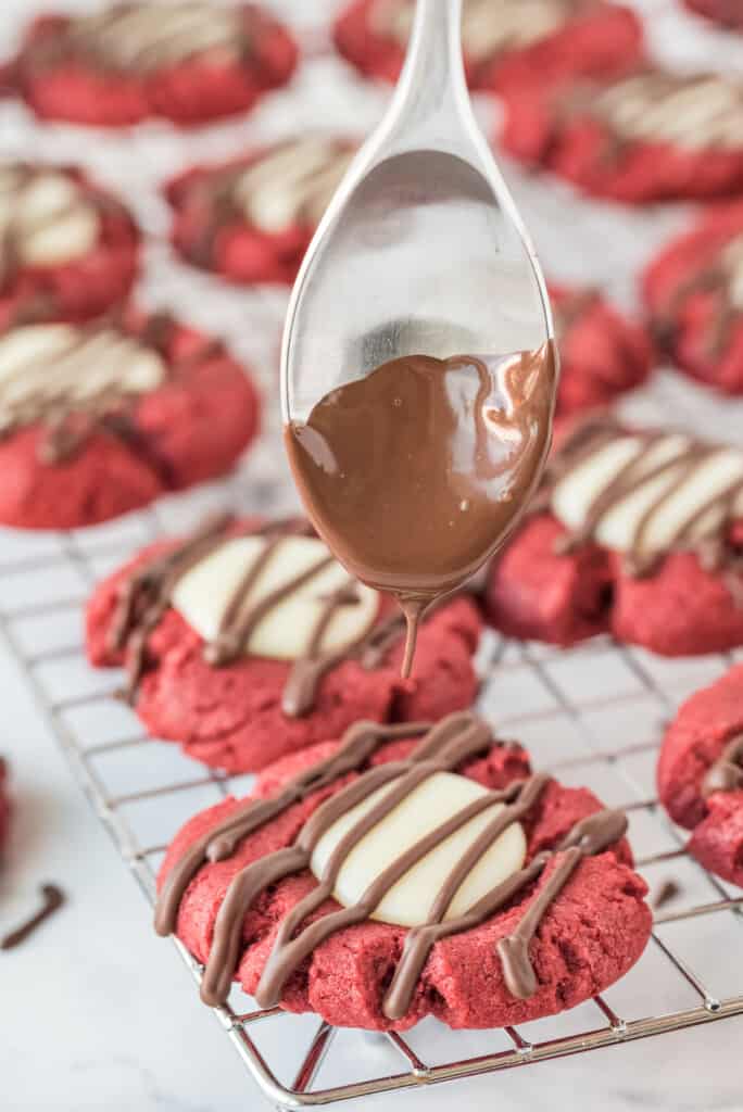Drizzling red velvet cookies with chocolate
