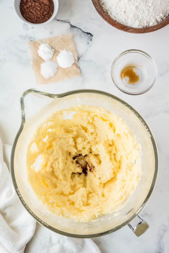 Creamed butter and sugar in glass mixing bowl