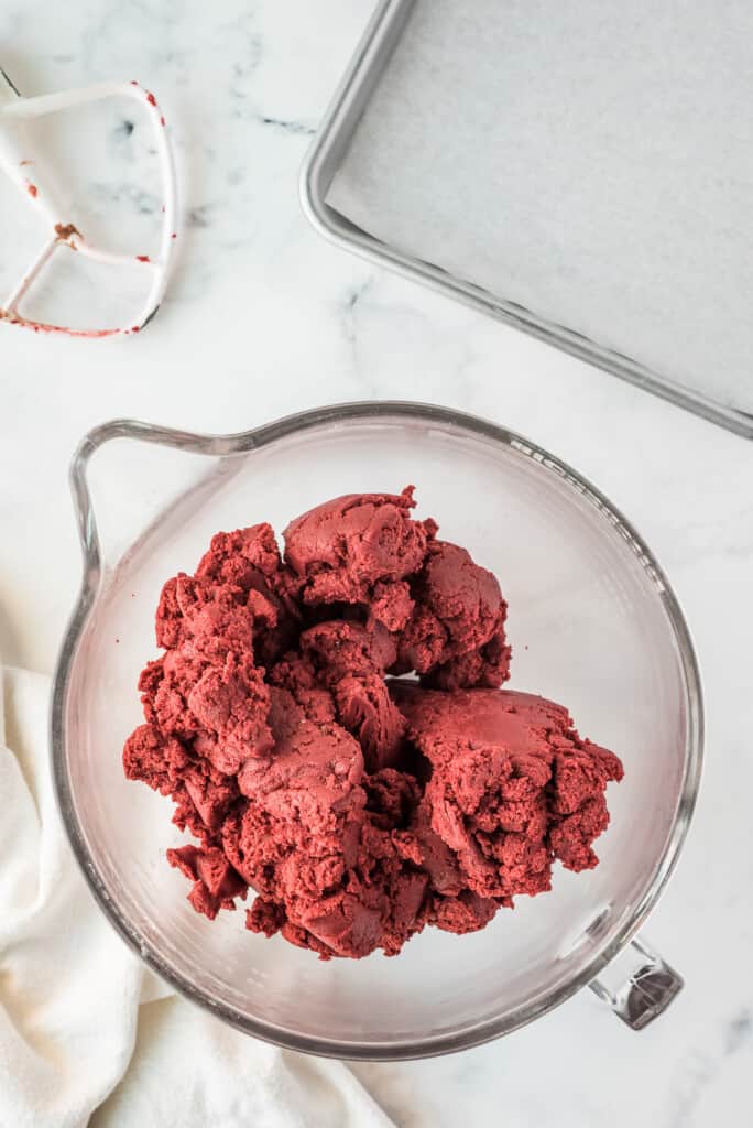 Mixed red velvet cookie dough in glass bowl