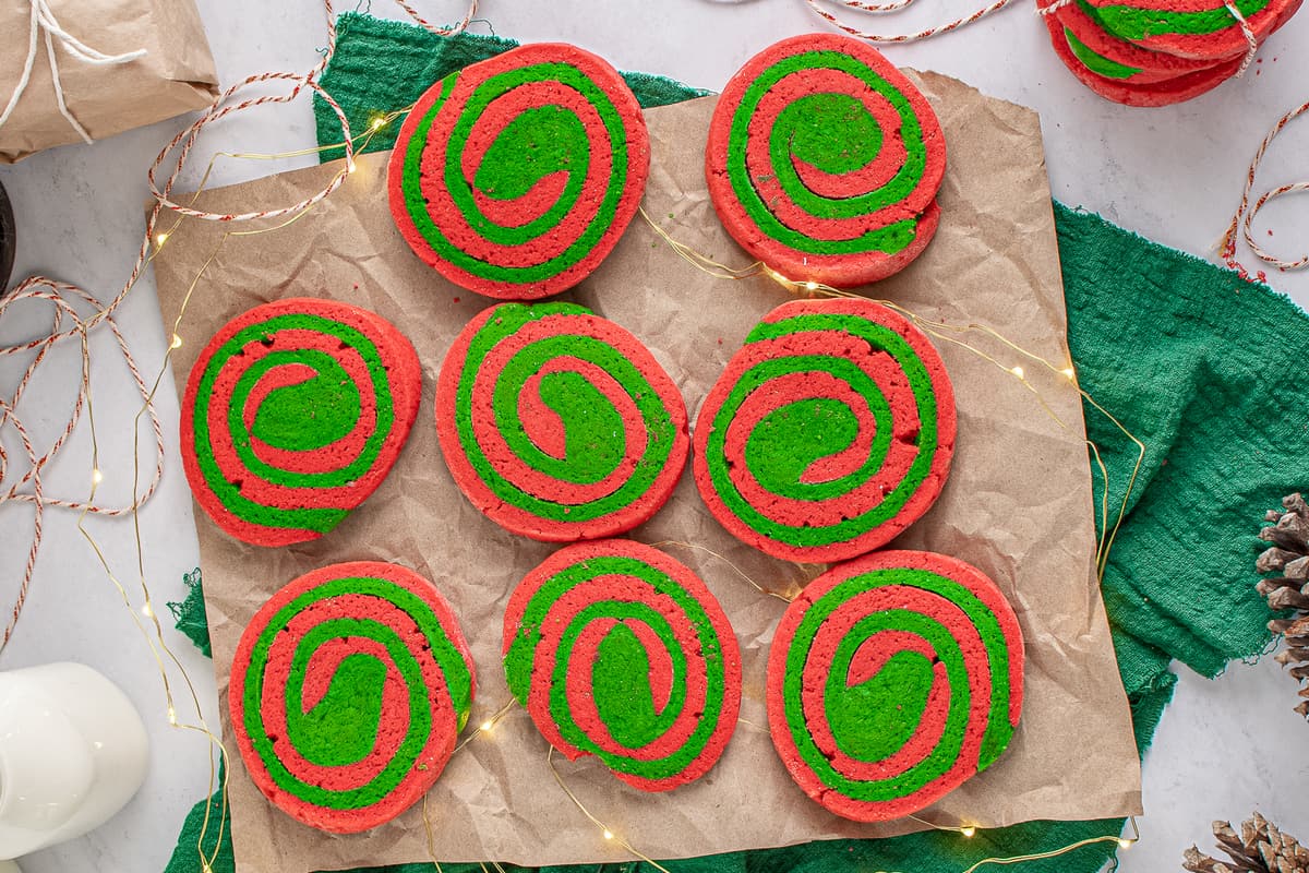Overhead image of Red and Green Pinwheel Cookies on brown parchment paper