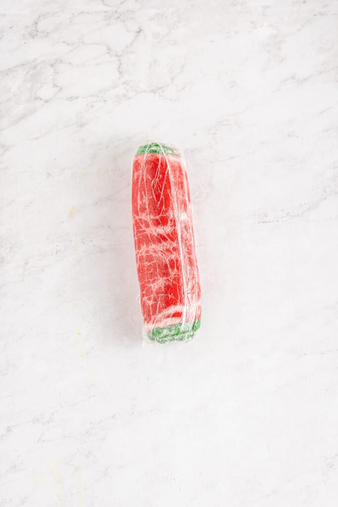 Log of red and green cookie dough rolled up