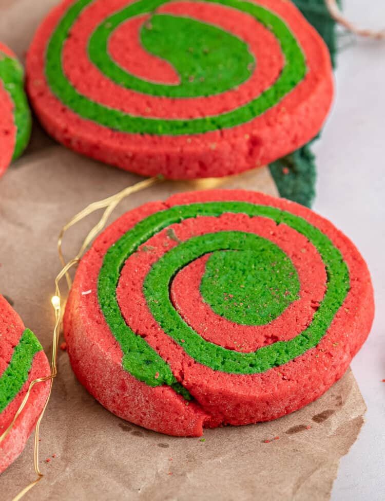 Red and Green Pinwheel Cookies on brown parchment paper