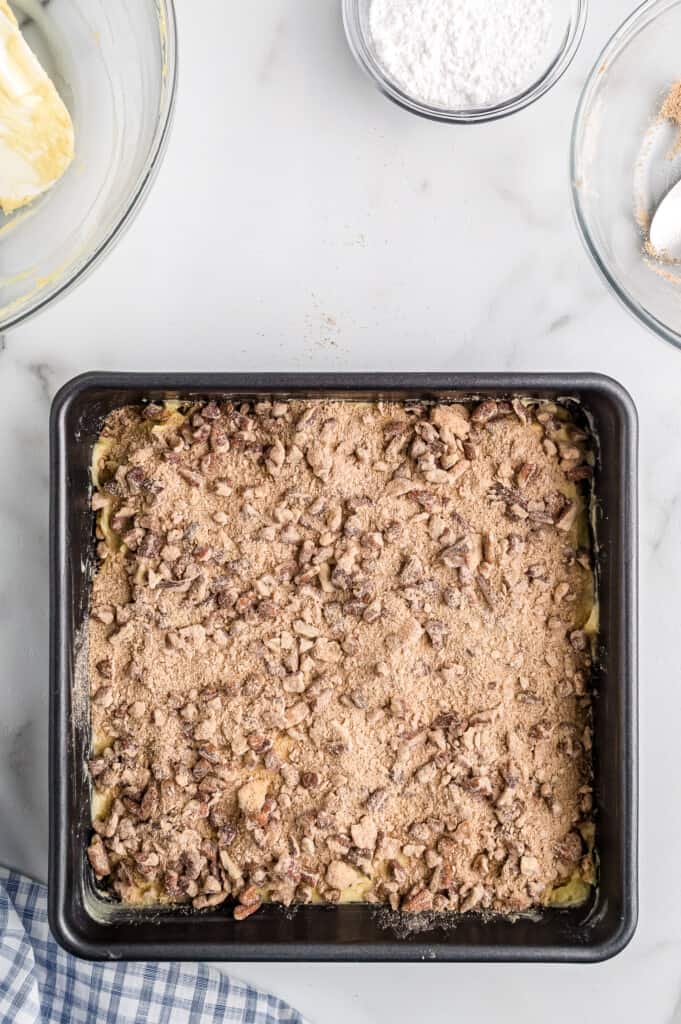 Overhead image of unbaked coffee cake with cinnamon pecan topping