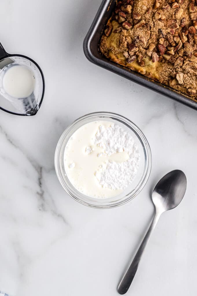 Overhead image of bowl of powdered sugar icing