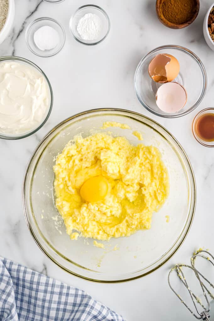 Overhead image of eggs being added to creamed mixture