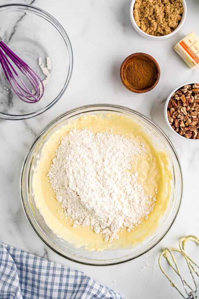 Overhead image of  of adding dry ingredients to wet ingredients in bowl