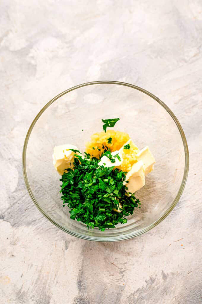 Small glass bowl with butter, parsley and garlic