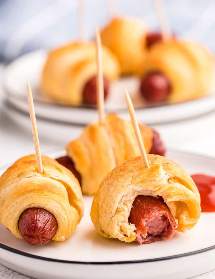 White plate with mini pigs on a blanket