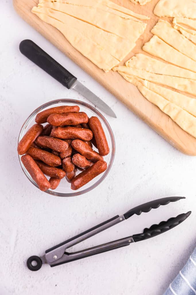 Bowl of cocktail weinies and crescent rolls