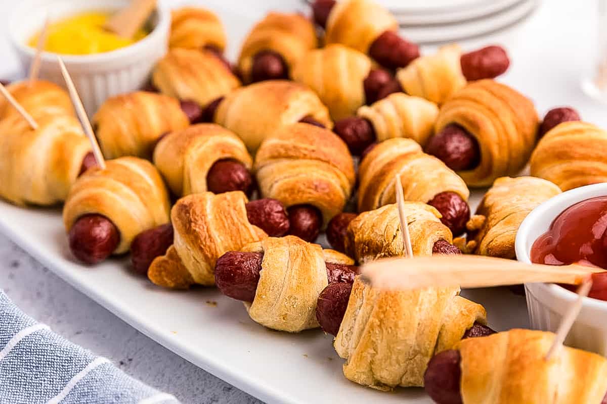 White platter with mini pigs in a blanket