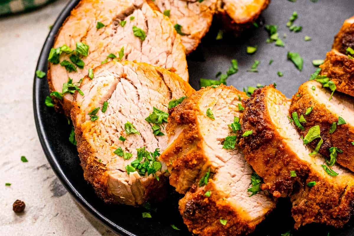 Slices of pork tenderloin on plate