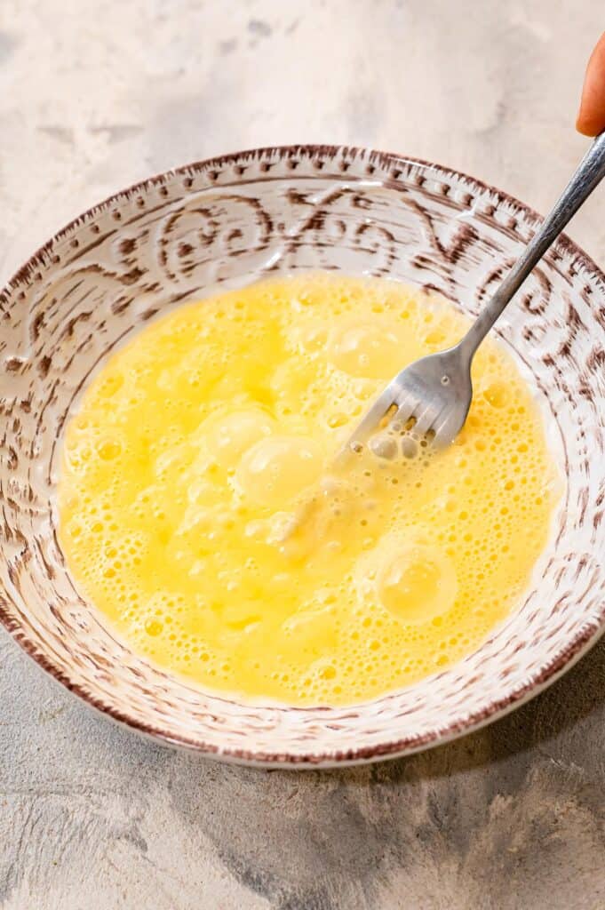 Bowl with whisked eggs in it
