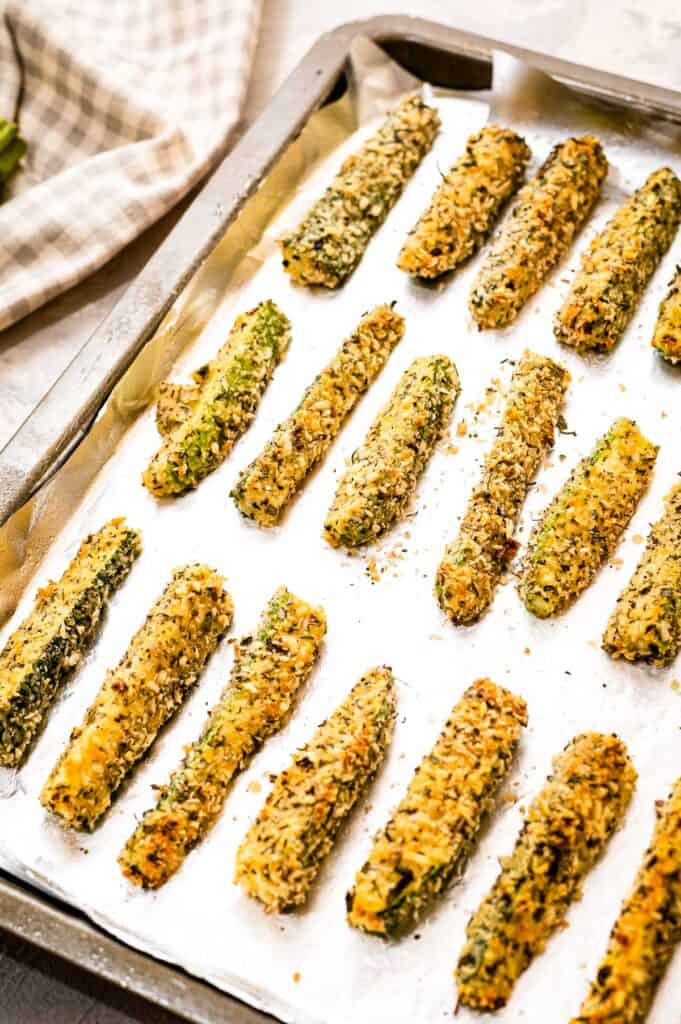 Zucchini fries on a lined baking sheet