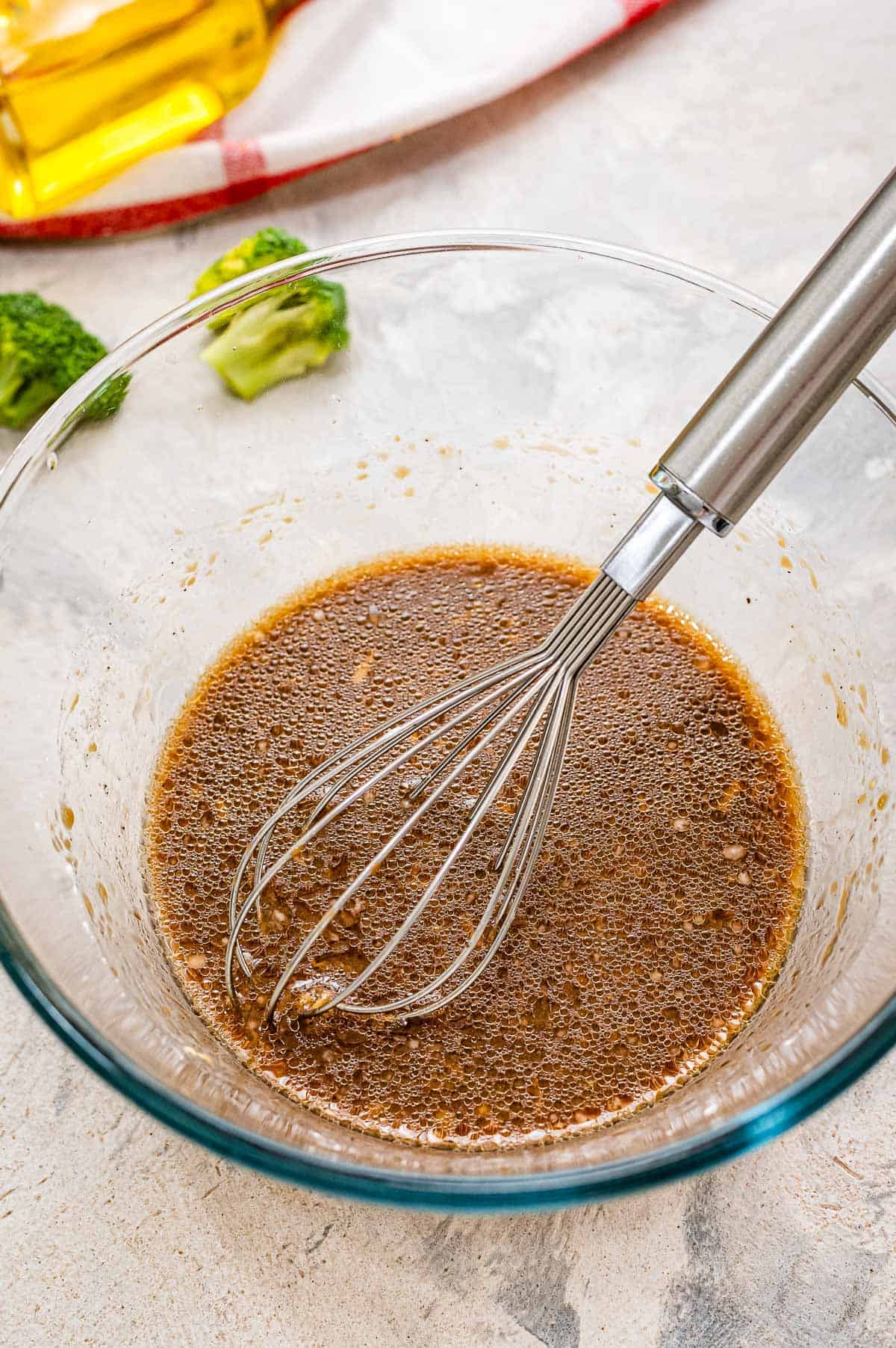 Glass bowl with sauce for beef and broccoli