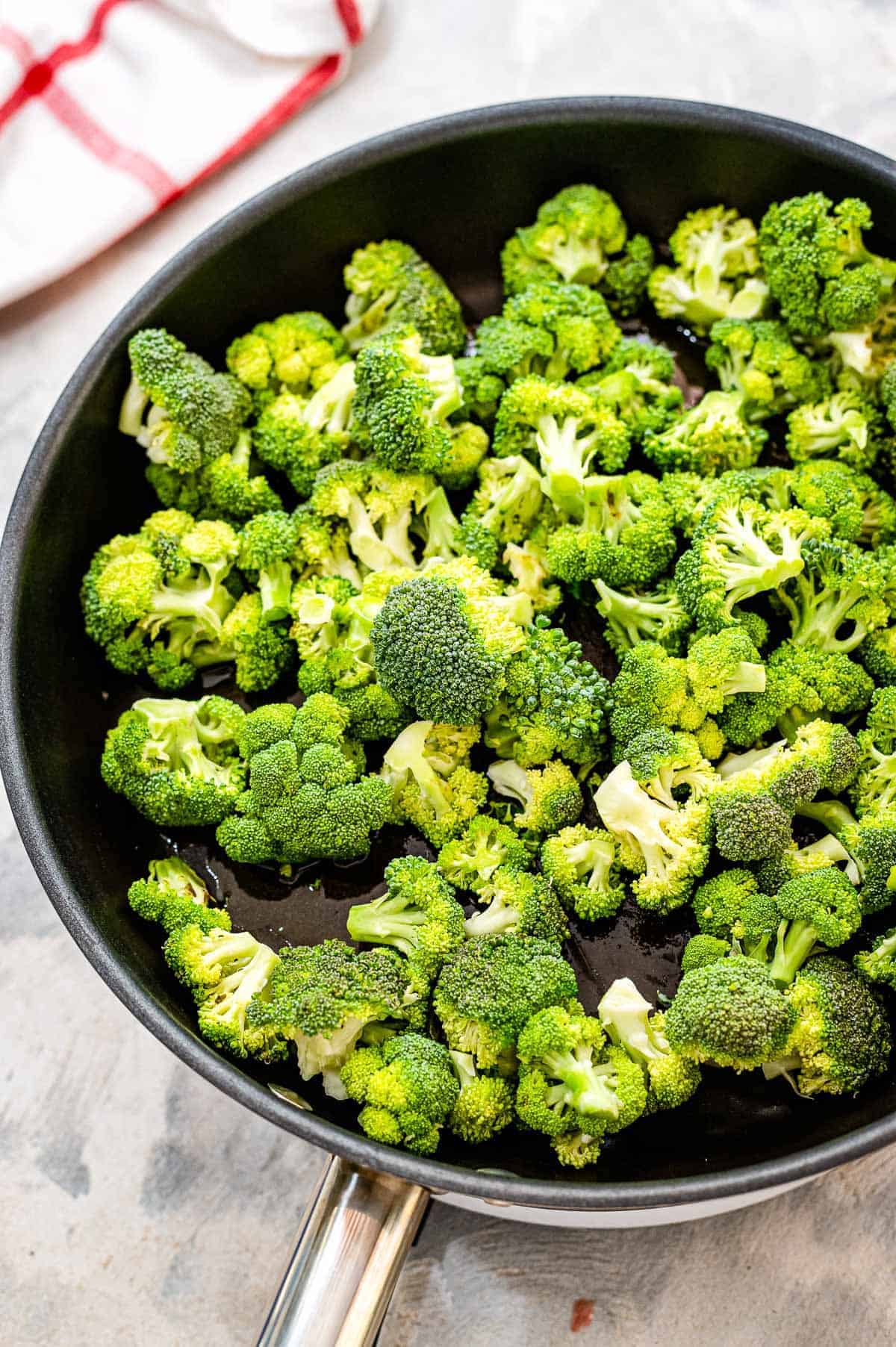 Fresh broccoli florets in skillet