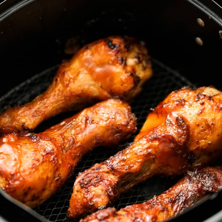 Air Fryer BBQ Chicken Legs in air fryer basket