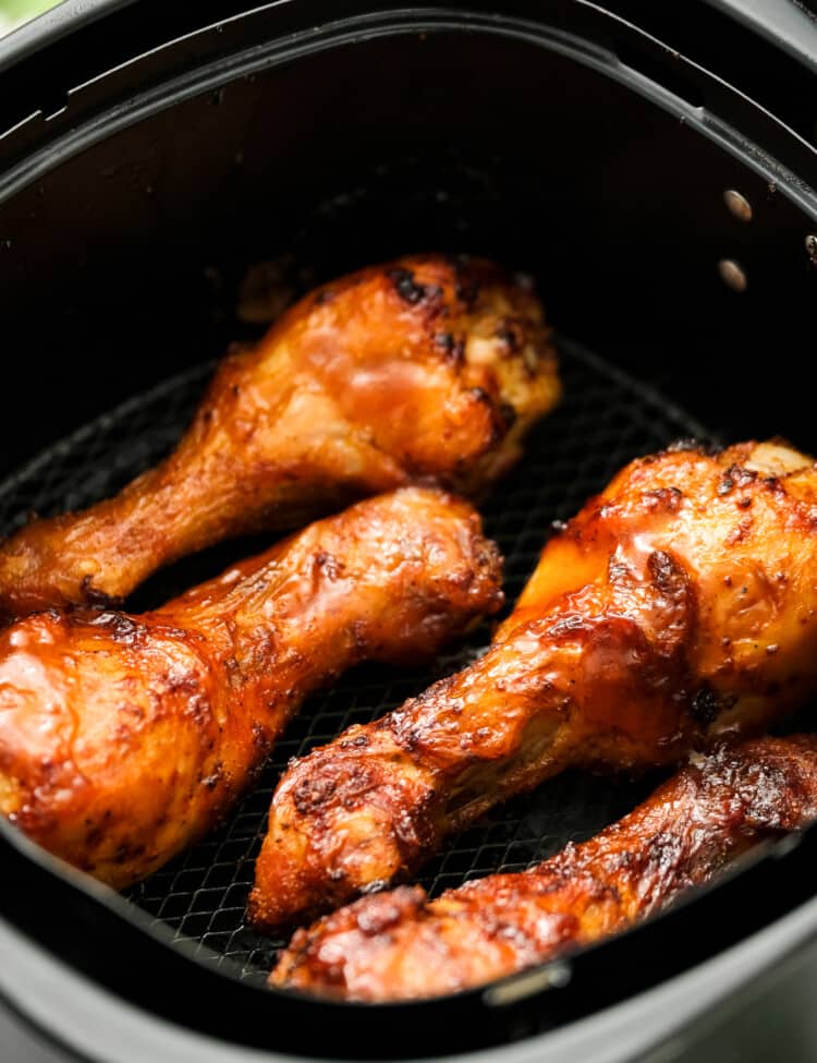 Air Fryer BBQ Chicken Legs in air fryer basket