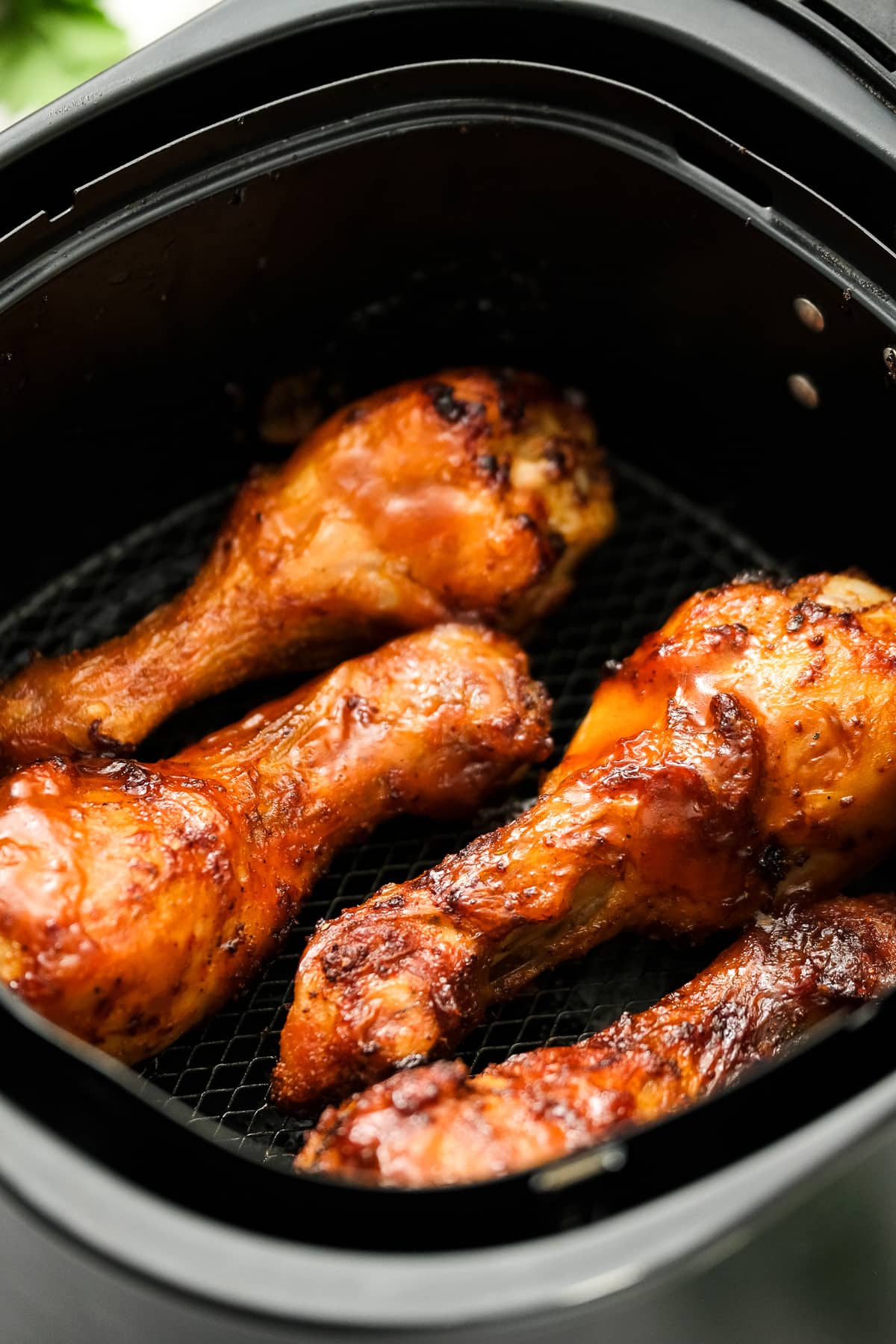 Air Fryer BBQ Chicken Legs in air fryer basket