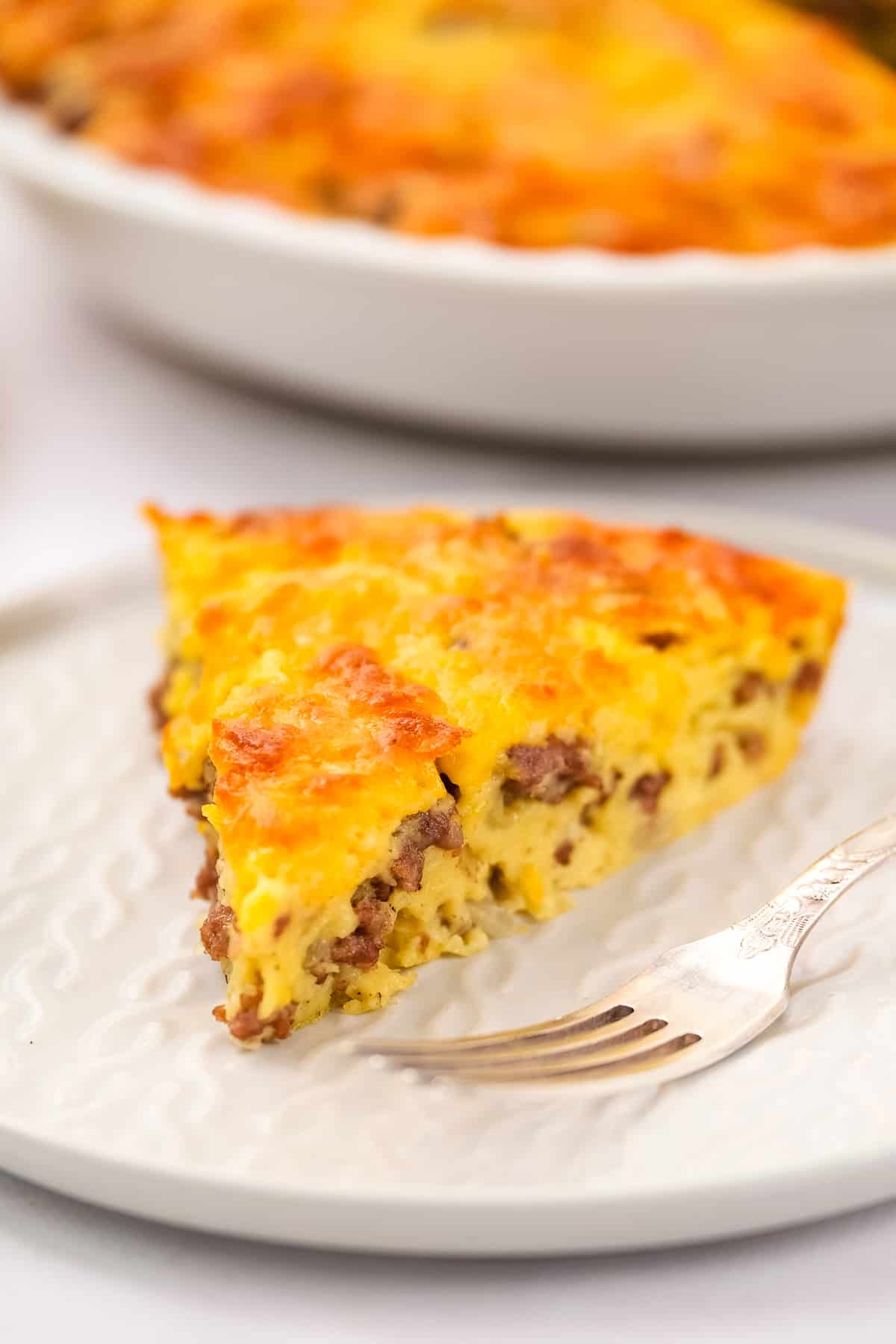 Slice of cheeseburger pie on white plate