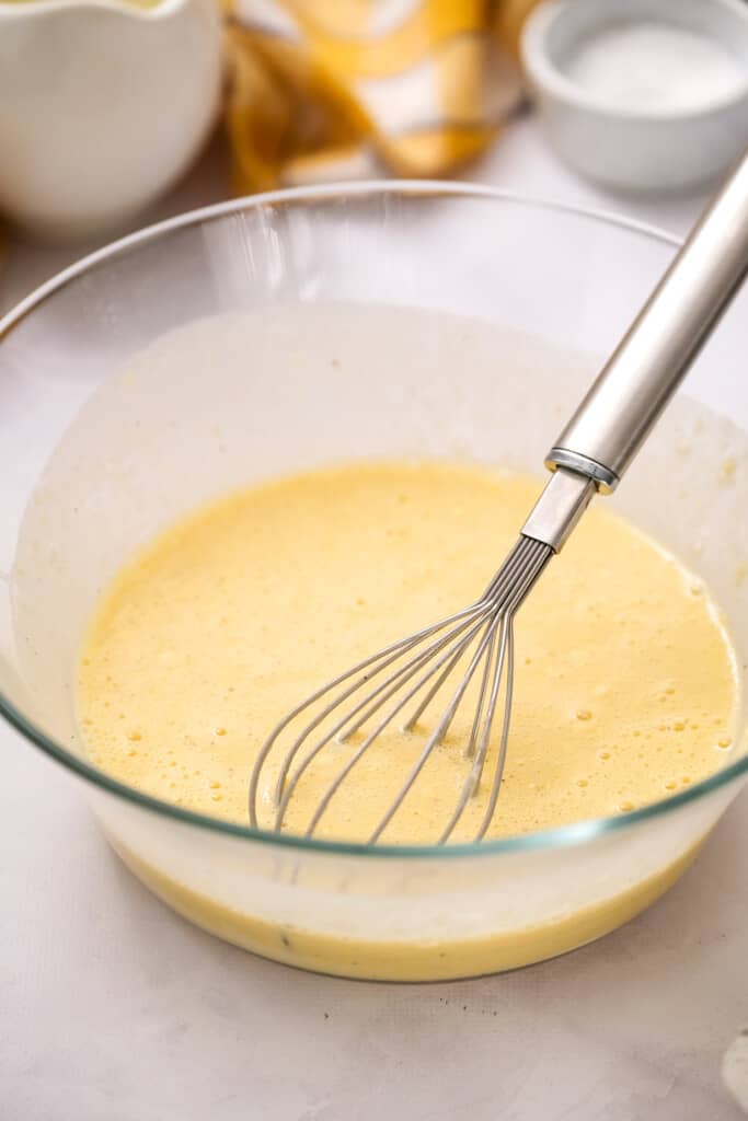 Glass bowl with bisquick batter and whisk