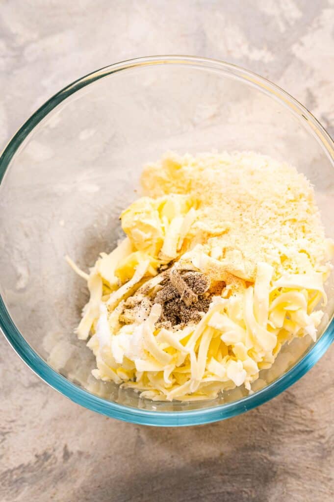 Glass bowl with garlic cheese mixture for bread before mixing