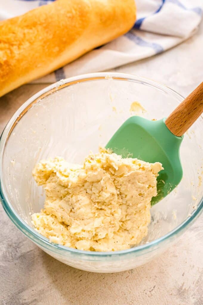 Glass bowl with mixed cheese topping for garlic bread