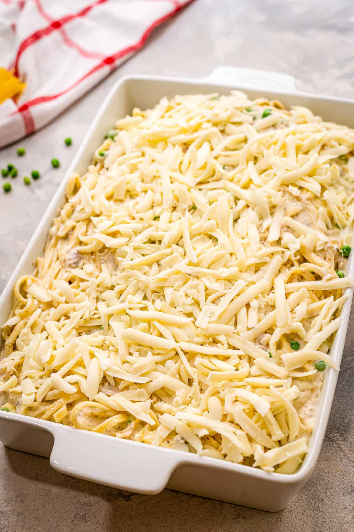 Unbaked tetrazzini casserole in white baking dish