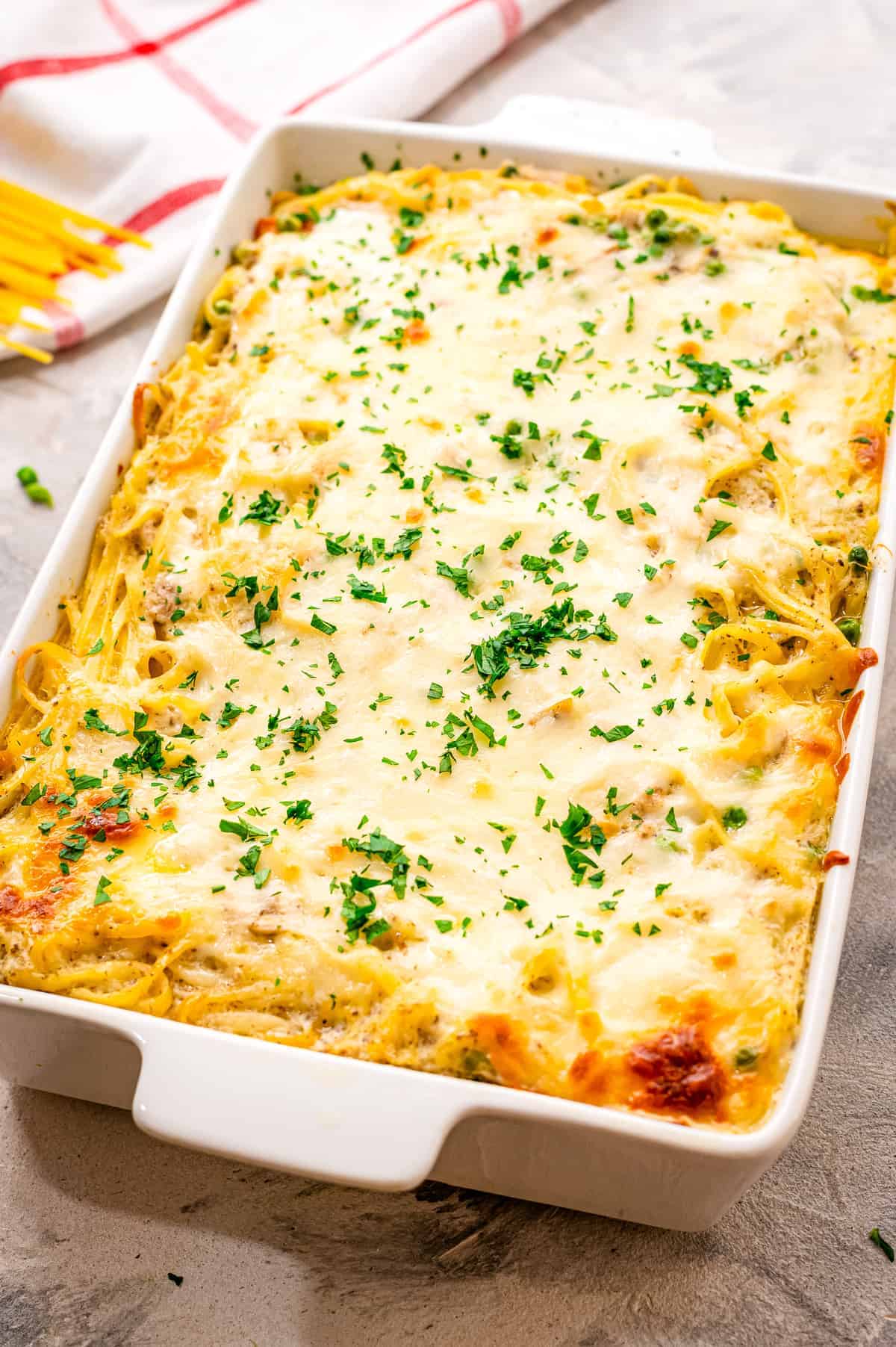 White casserole dish with baked Chicken Tetrazzini