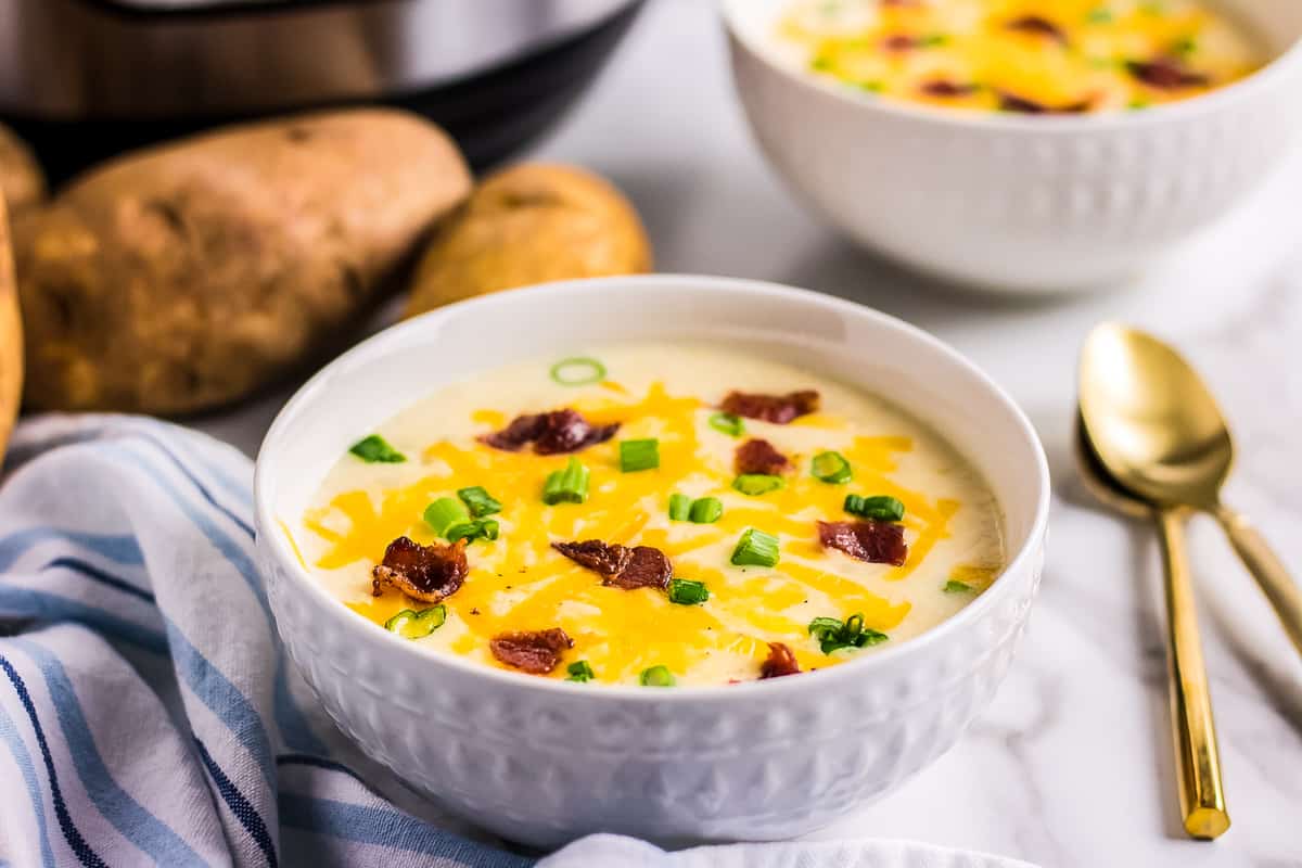 Bowl of potato soup with bacon, cheese and green onions