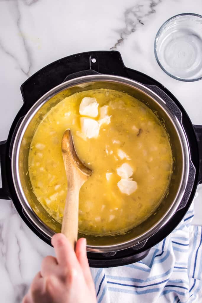 Stirring cream cheese into soup