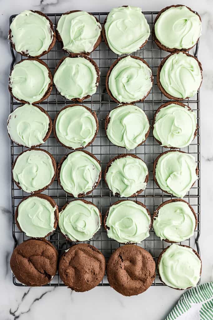 Chocolate cookie topped with mint filling and some topped with a chocolate cookie