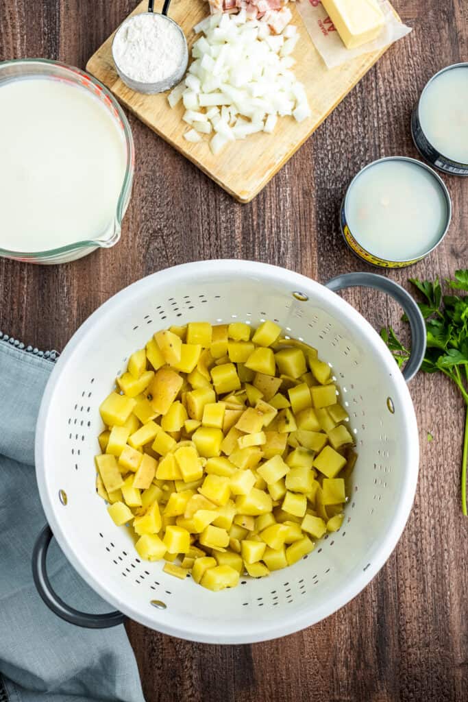 Colander with cooked and cubed yukon gold potatoes in it