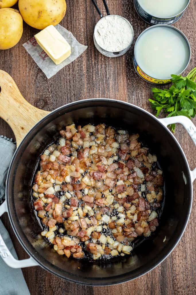 Stock pot with onions and bacon frying