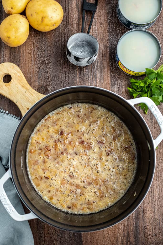 Stock pot with butter, bacon and onions cooking