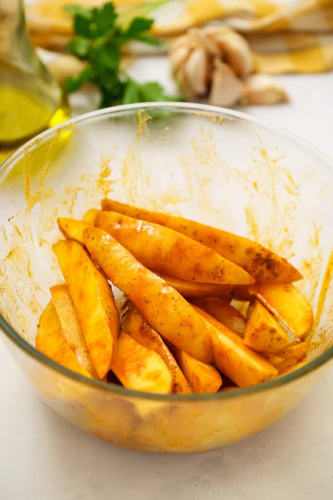 Bowl of seasoned potato wedges