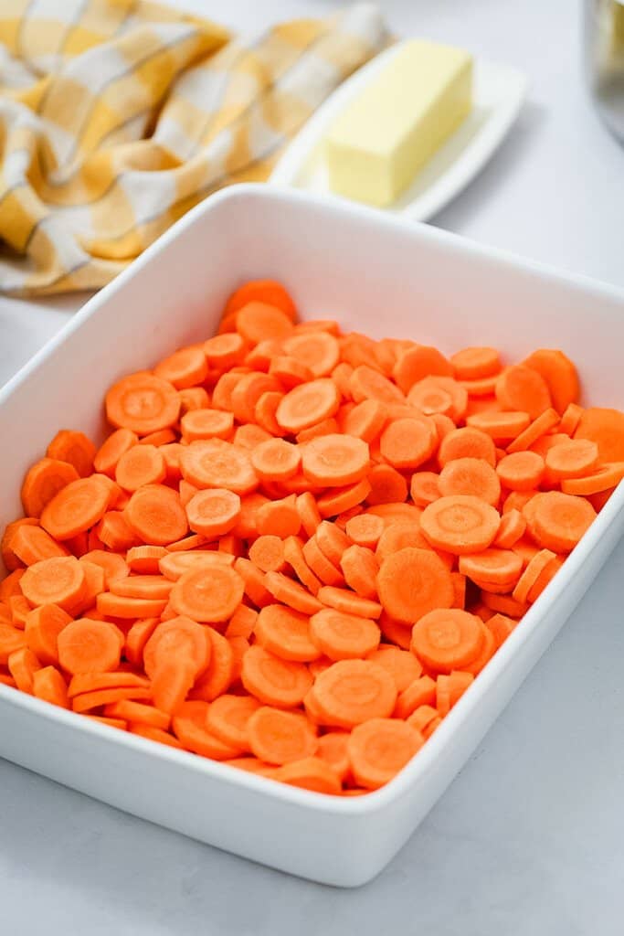 White casserole dish with sliced carrots