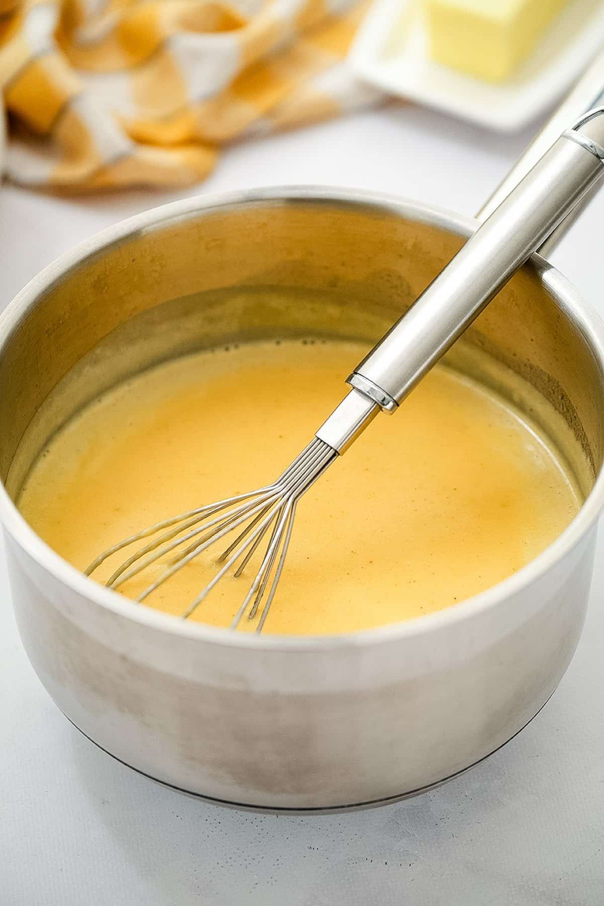 Saucepan with cheese sauce