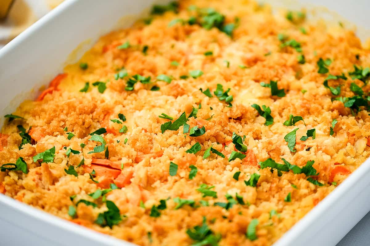 Cheesy carrots in casserole dish topped with crackers
