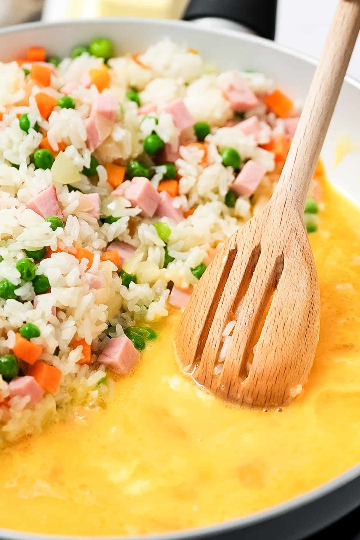 Scrambling eggs in skillet for fried rice