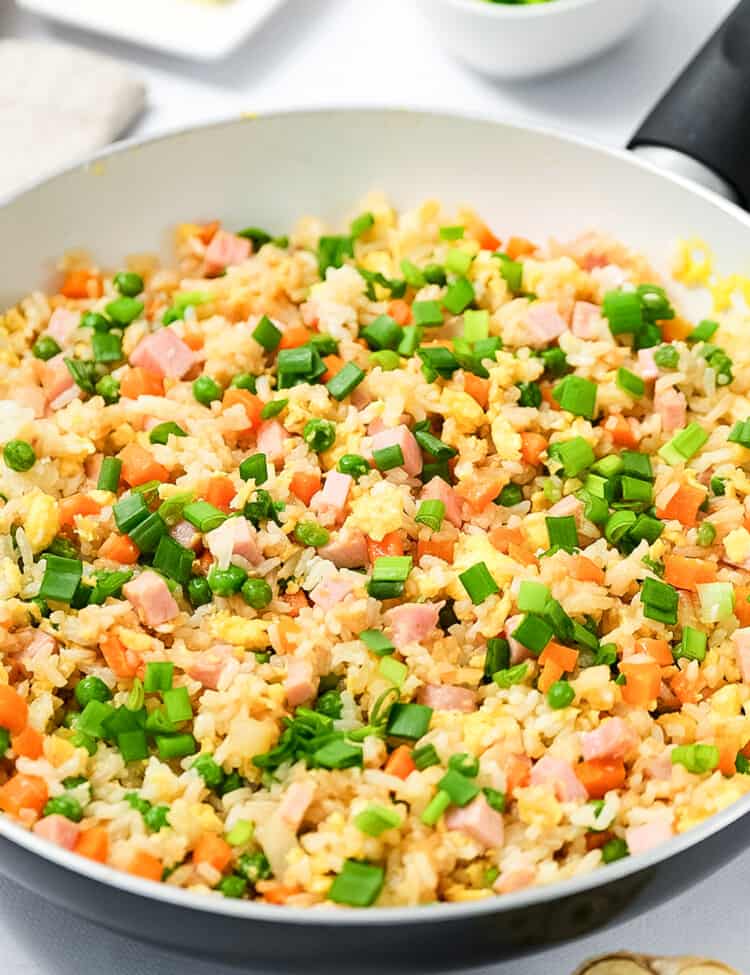 Skillet with ham fried rice in it