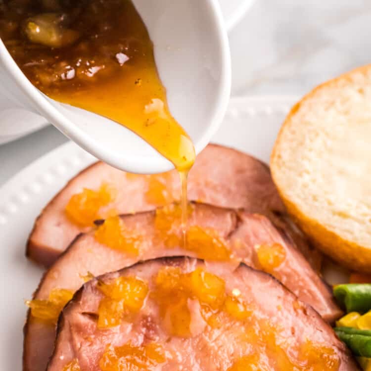 Pouring Pineapple Glaze over ham