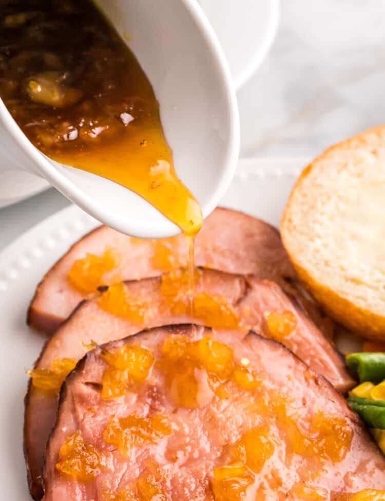 Pouring Pineapple Glaze over ham