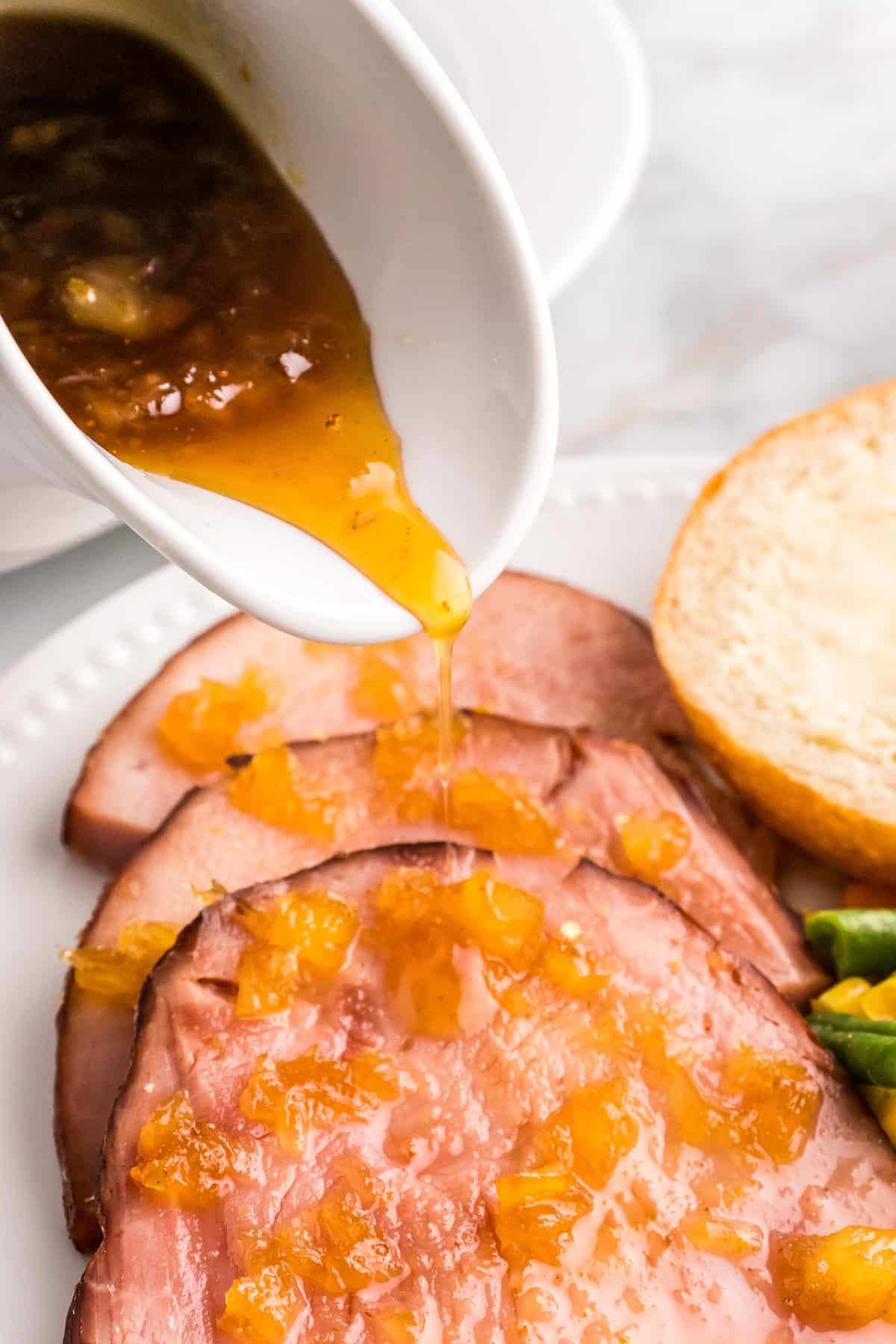 Pouring Pineapple Glaze over ham