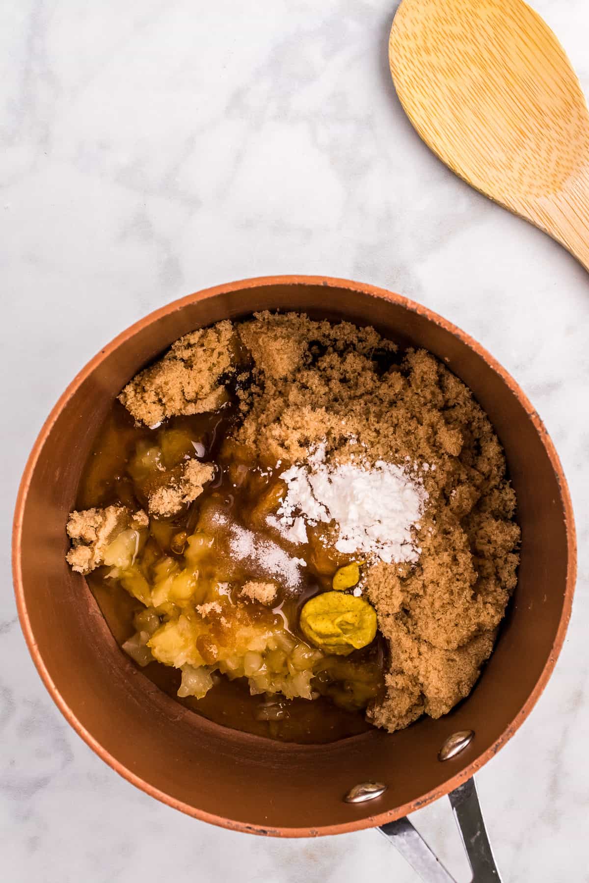 Overhead image of saucepan with pineapple glaze ingredients