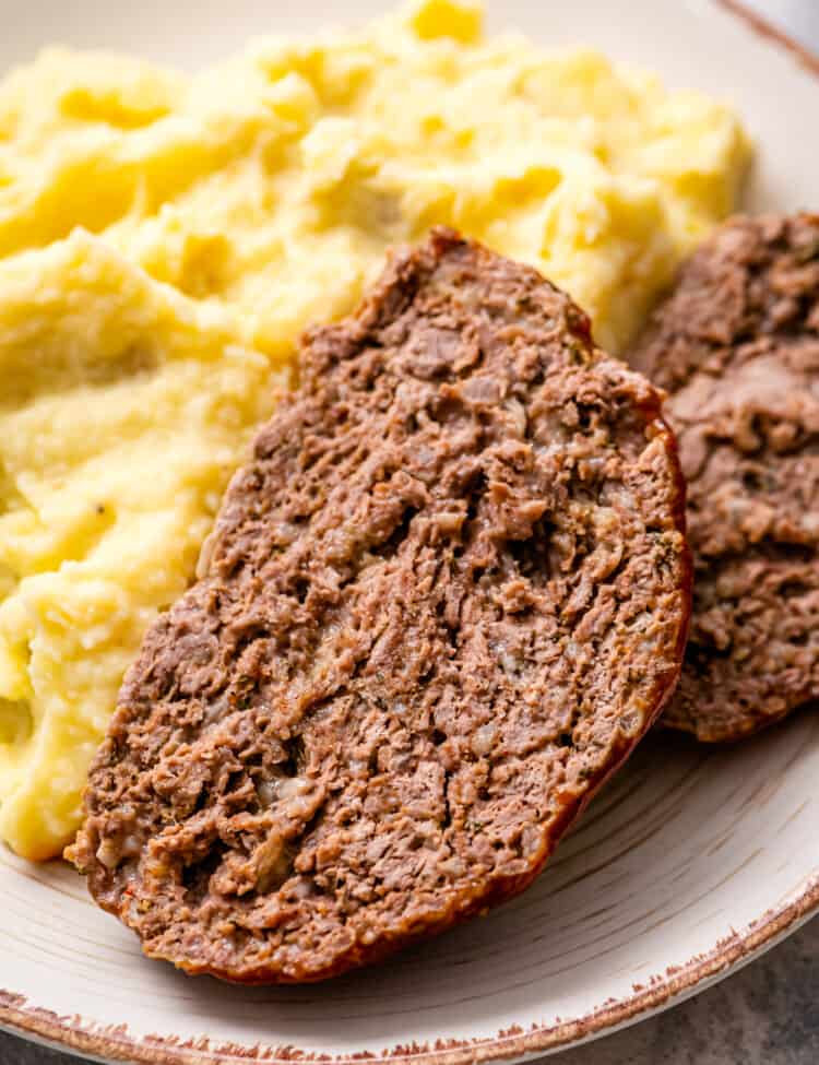 Sliced Meatloaf and mashed potatoes on plate