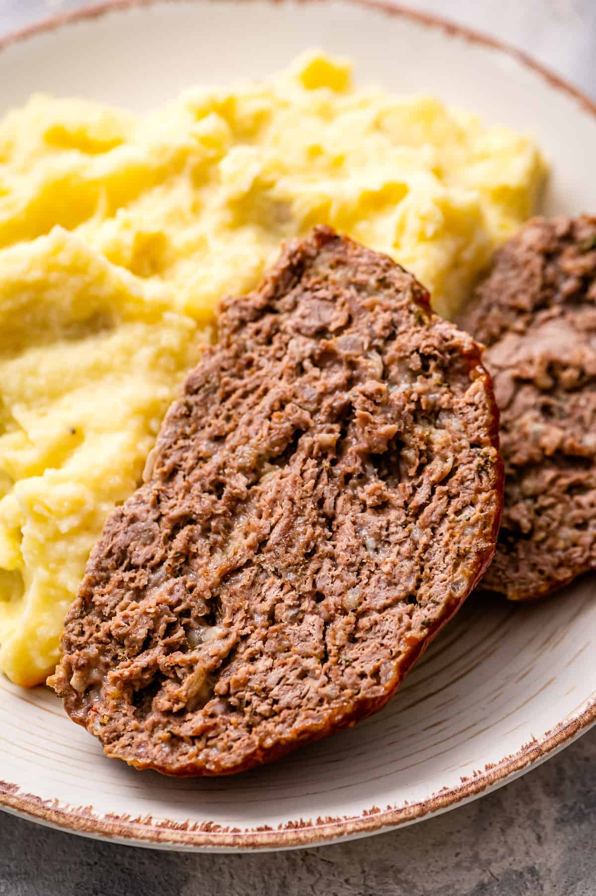 Sliced Meatloaf and mashed potatoes on plate