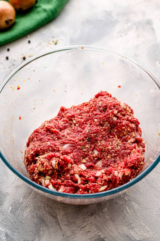 Glass bowl with meatloaf ingredients mixed together