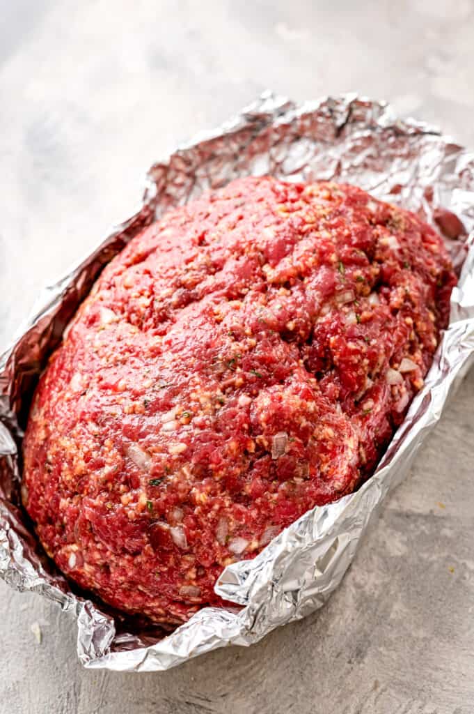 Raw meatloaf in a tinfoil pocket