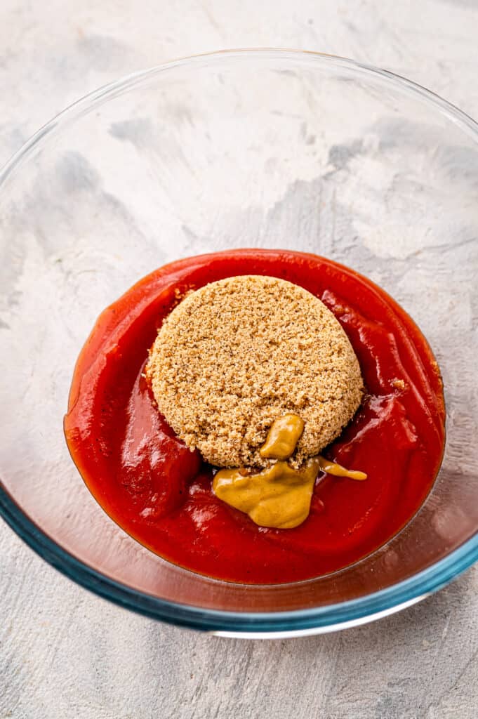 Glass bowl with ketchup sauce ingredients for meatloaf